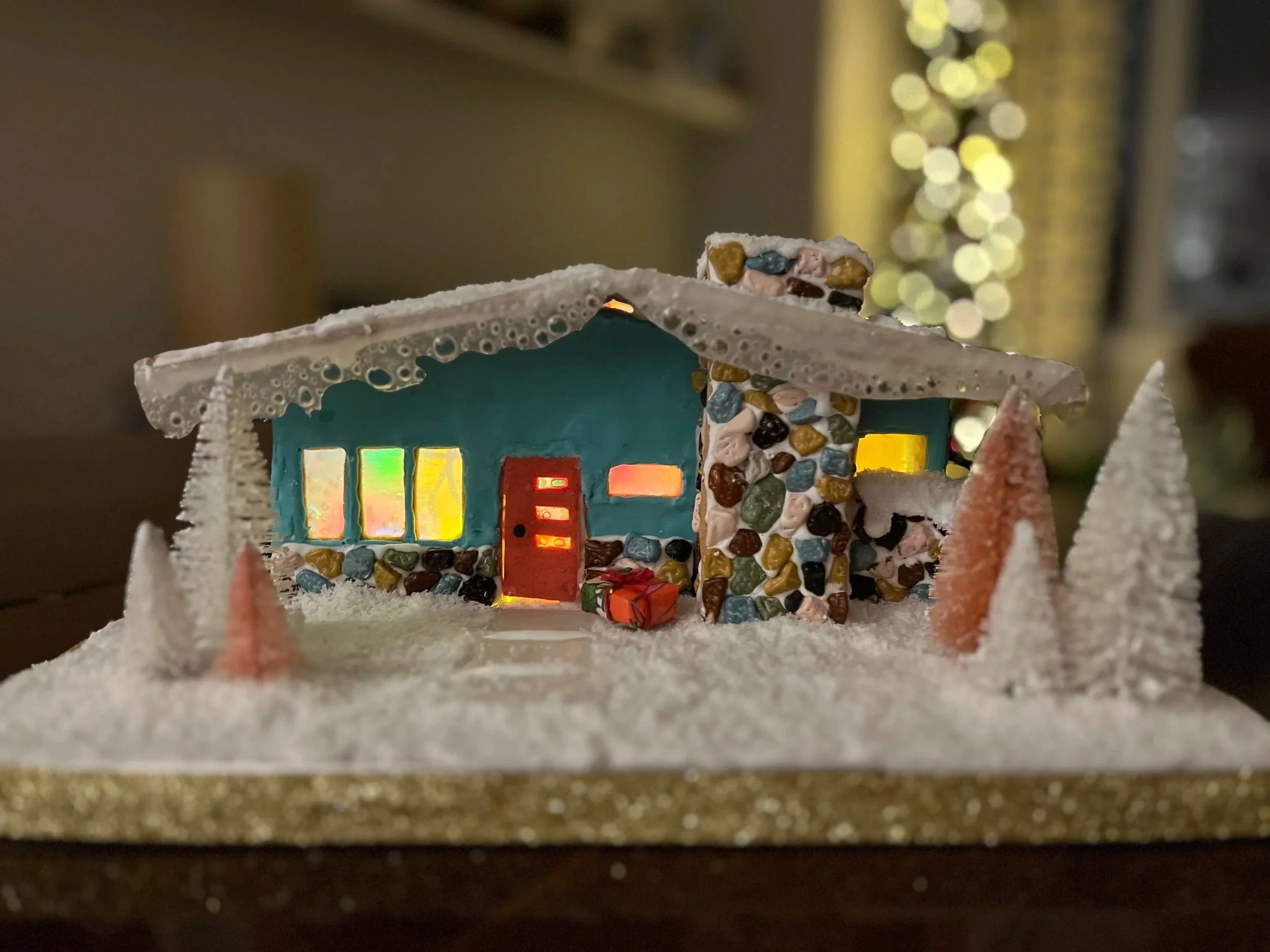 A lit up mid century gingerbread house