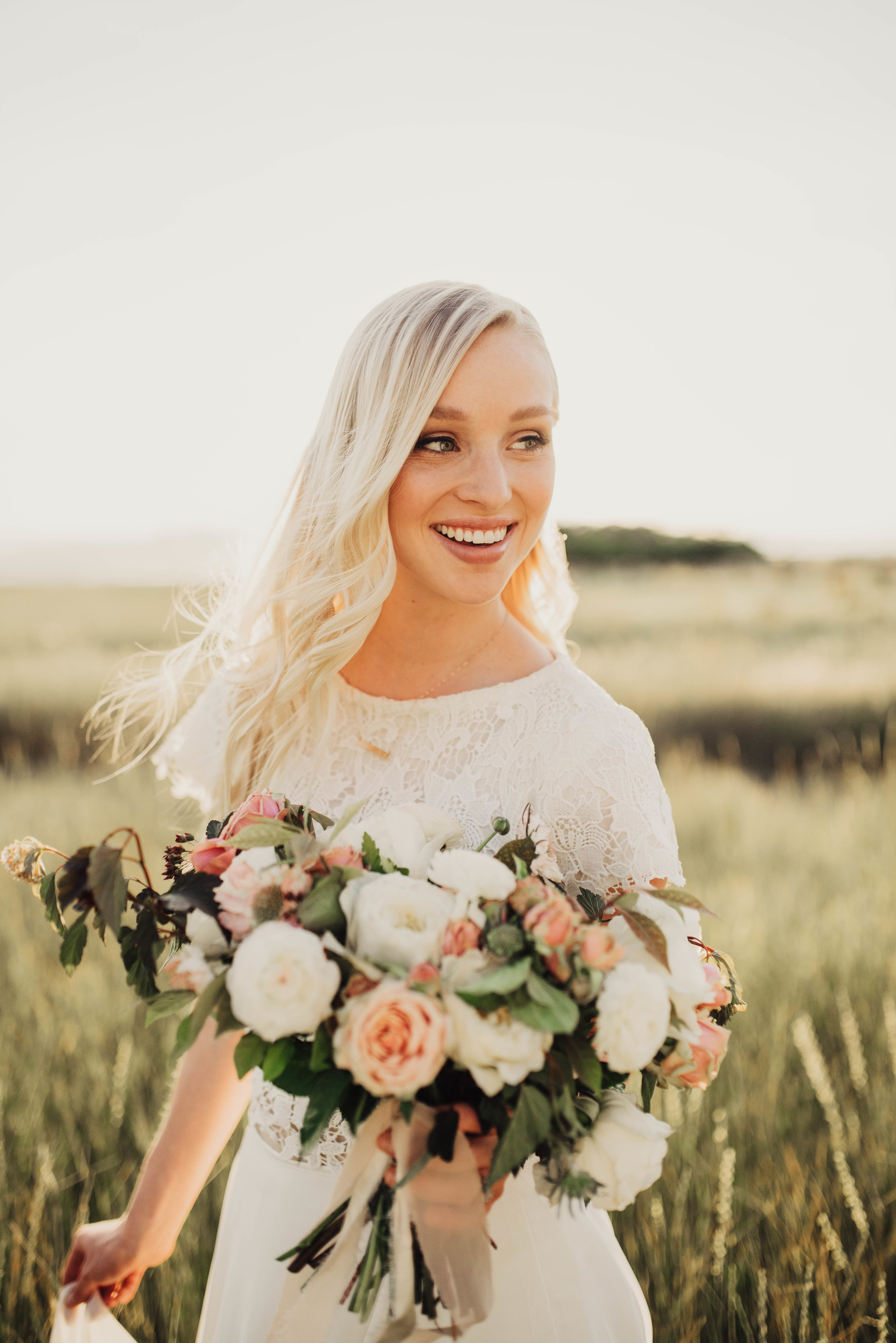 Laughing bride with large bouquet