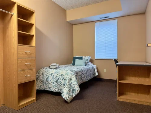 Standard Suit Bedroom, with twin bed, chair and desk
