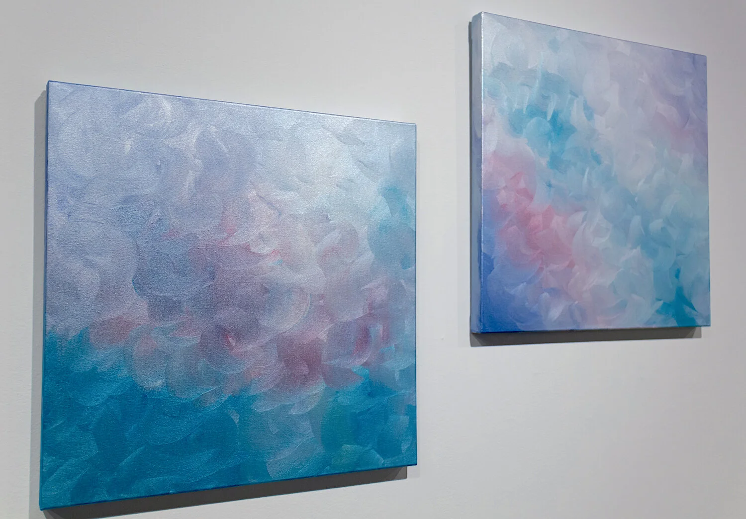 The Portal Closes (right) with her sister piece, The Portal Opens (left) at the exhibit “Liminal &amp; Luminous”