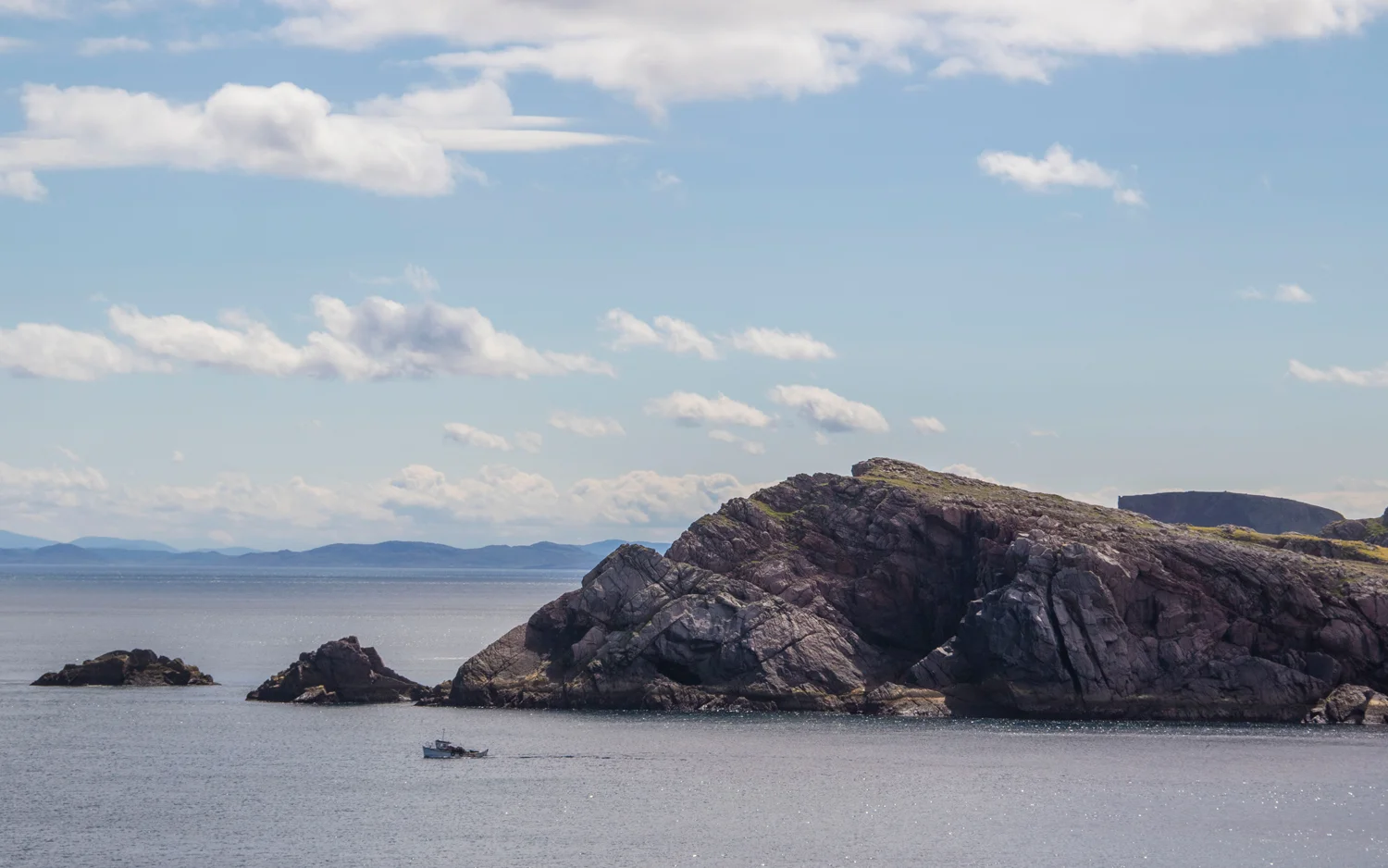 Mearnaid Rock by day. Mainland Donegal can be seen in the far distance.