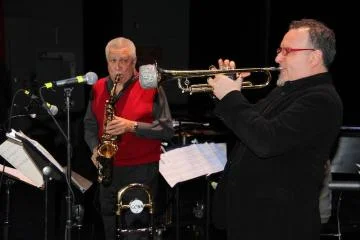 Performing with Paquito D'Rivera (featured in red, next to trumpeter Diego Urcola) requires "passion, seriousness, and respect for what you play," says Berklee Latin Jazz Program academic director Oscar Stagnaro.