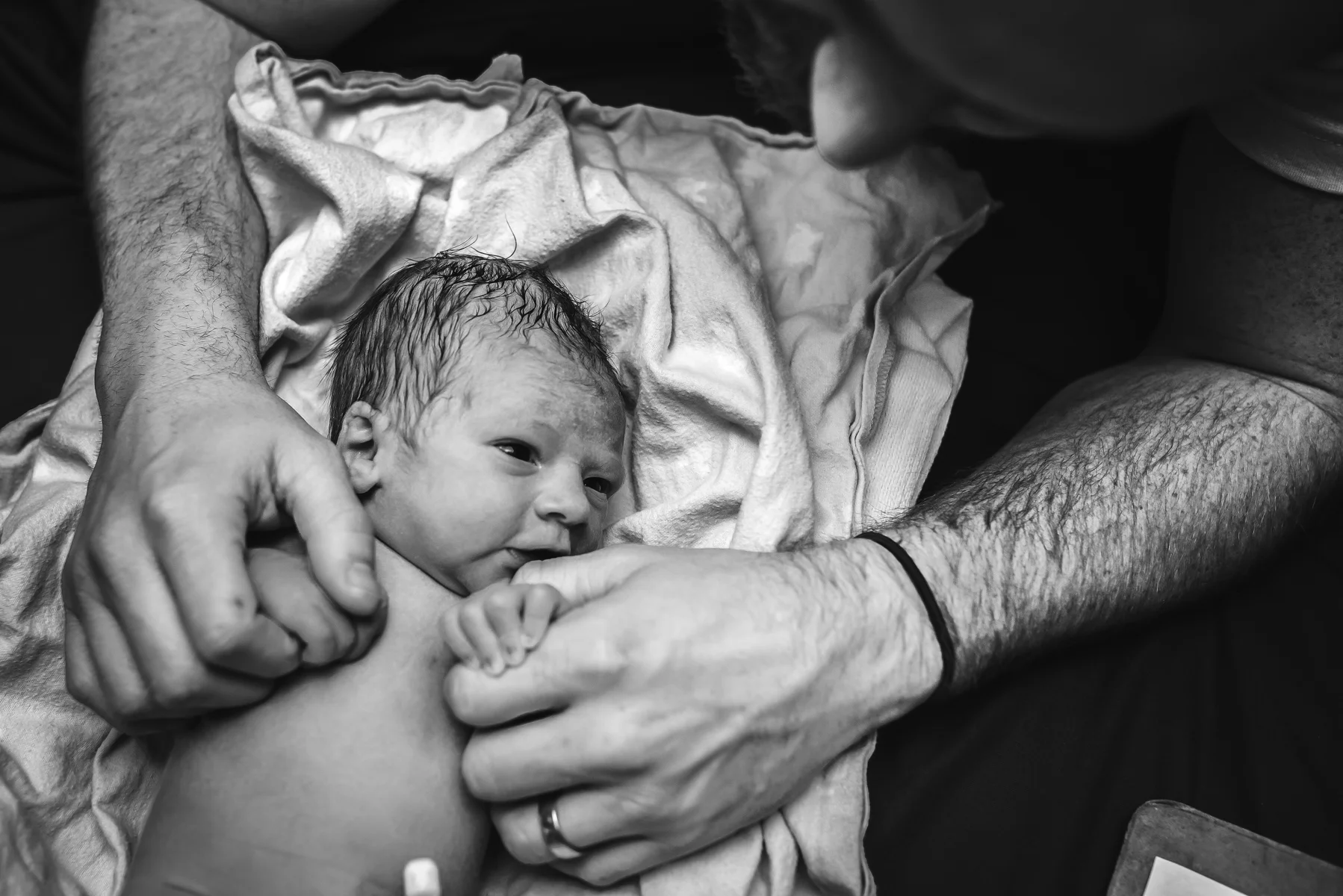 denver-birth-photographer-mountain-midwifery-fathers-hands