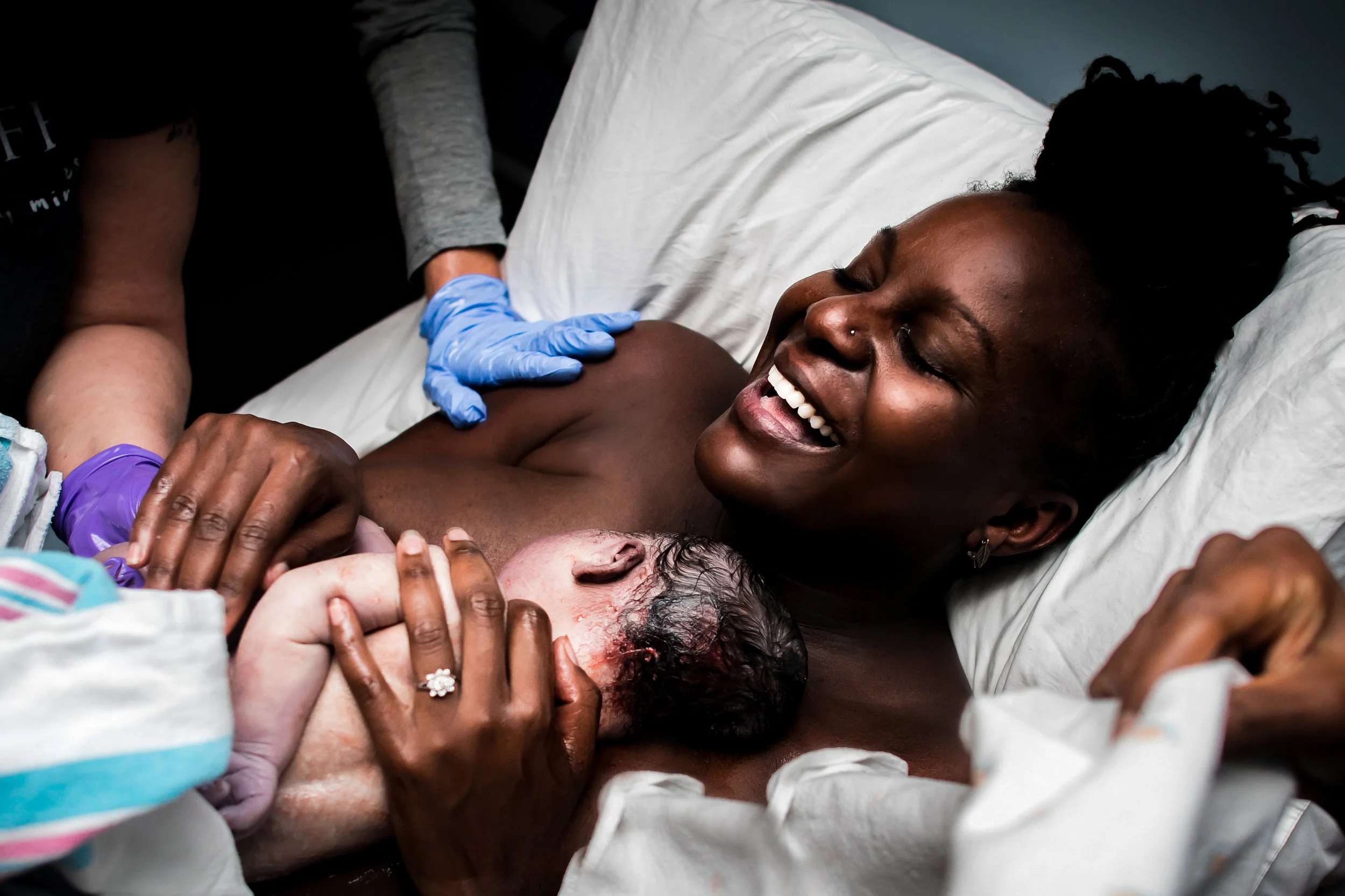 mom holds baby on chest at denver center for birth