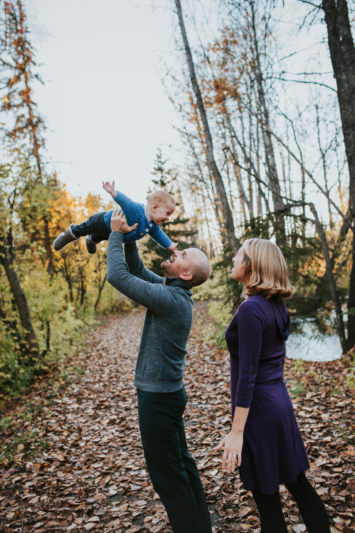dad flying baby in anchorage park