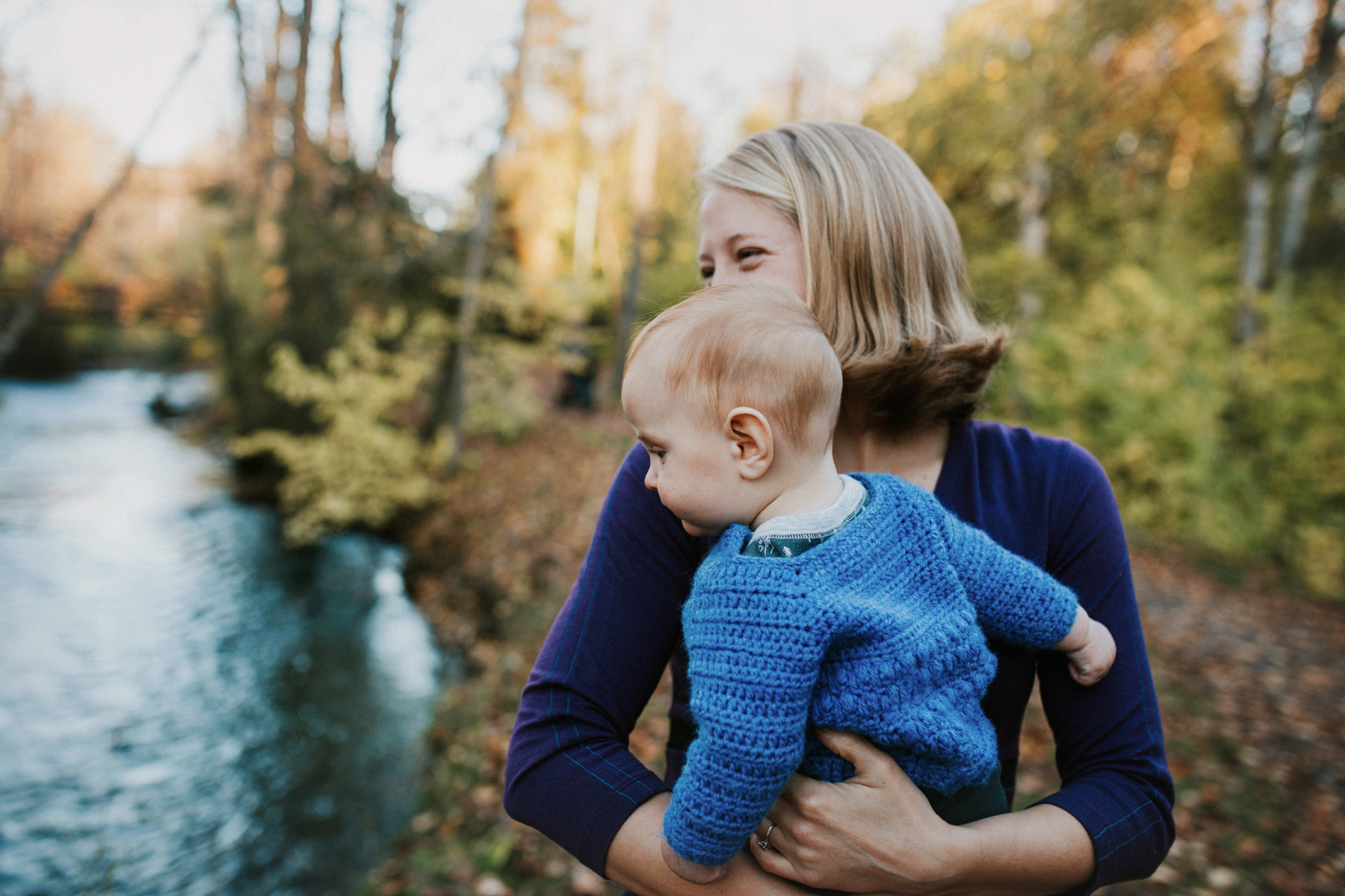mom smiling holding baby in anchorage