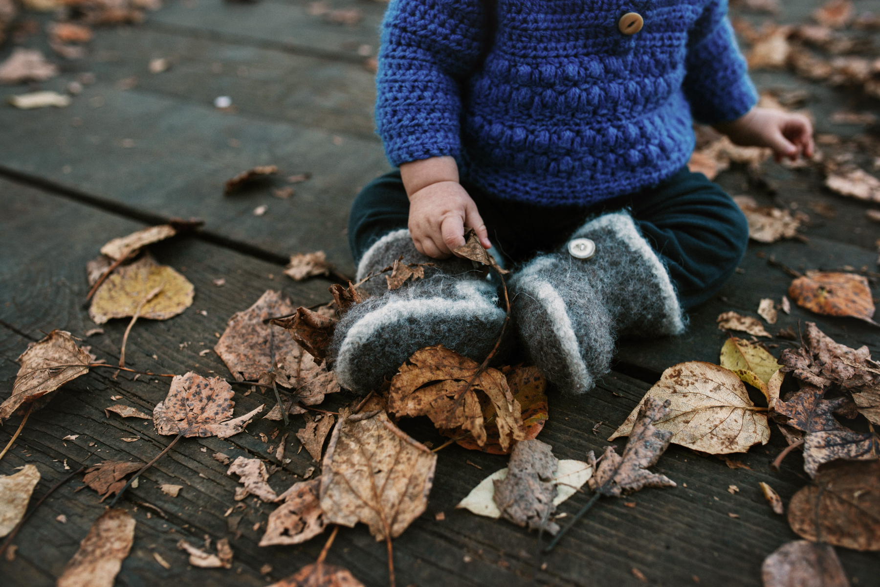 baby in fall leaves