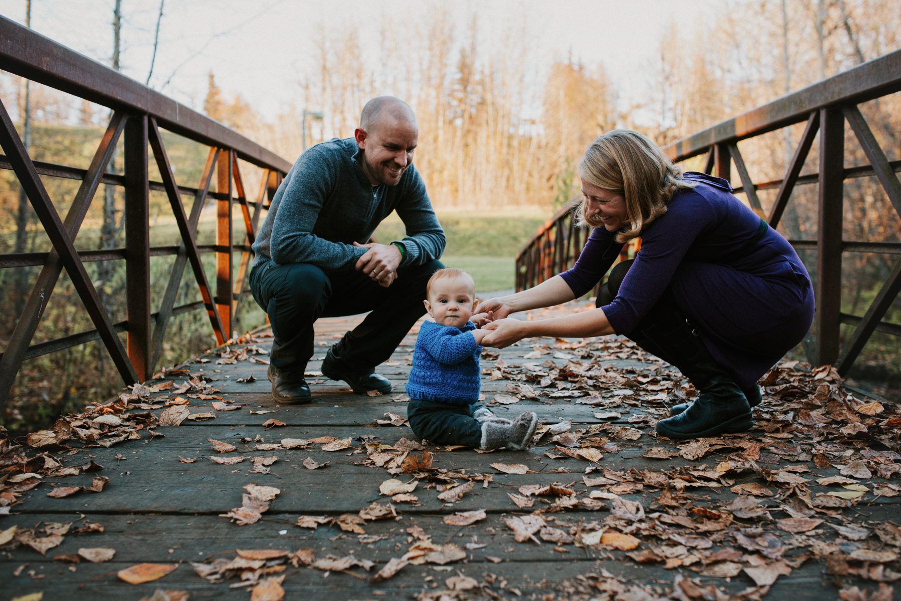 family on bridge with baby