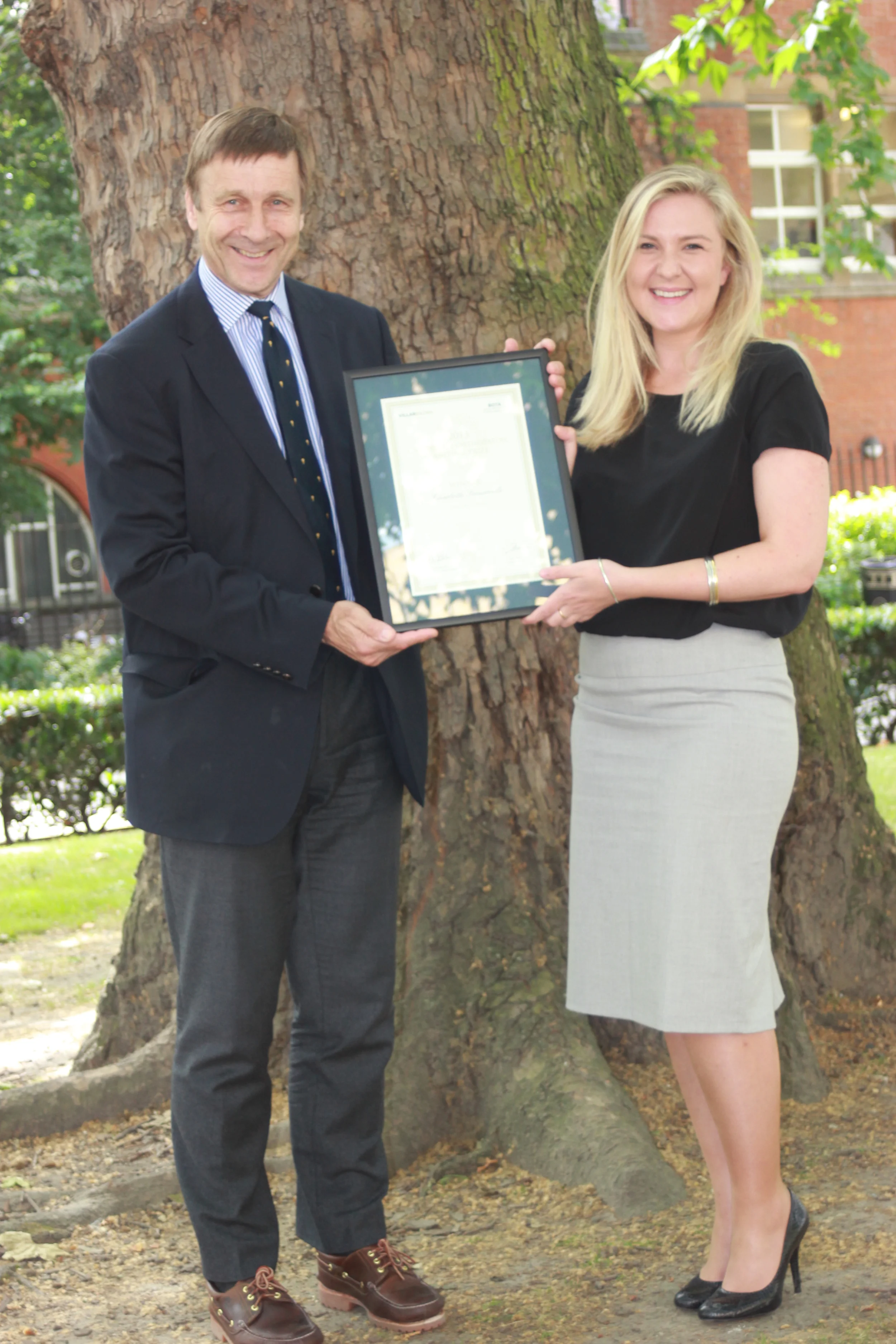 Charlotte receives her certificate and prize money from Mr Richard Villar of the Villar Bajwa Practice .