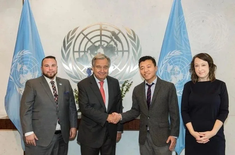 UN-GLOBE Board members Hyung Nam Hak and Gabe Galaxy and volunteer Jenn Rumbach meet with the UN Secretary-General António Guterres in 2017.