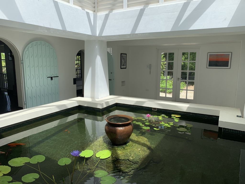 The koi pond, covered by a clerestory roof, forms the centre of the villa.