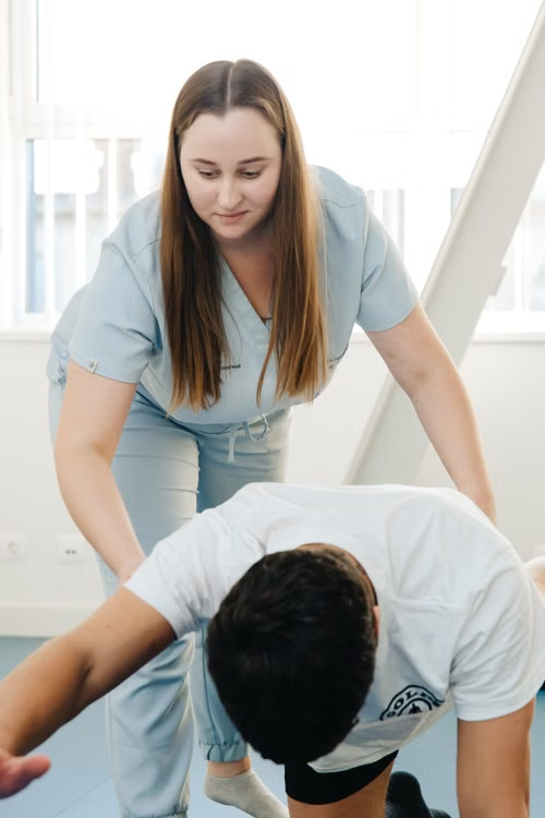 An occupational therapist works with a patient.