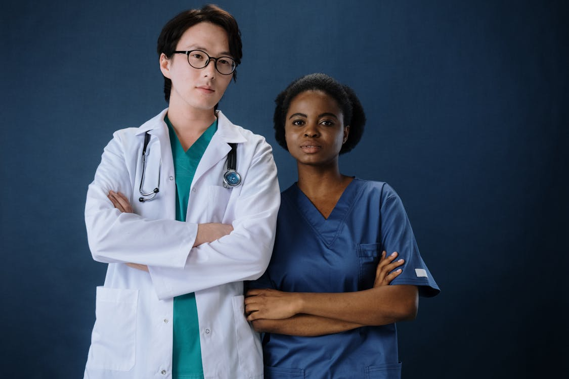 A doctor and nurse in scrubs.