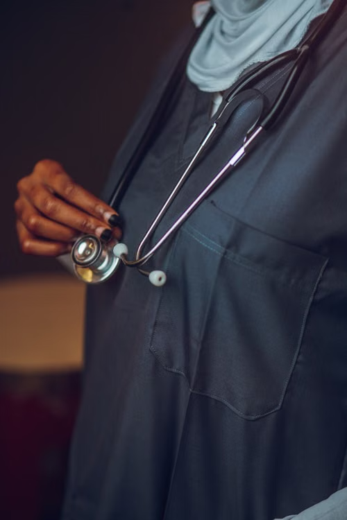 A doctor wears medical clothing.