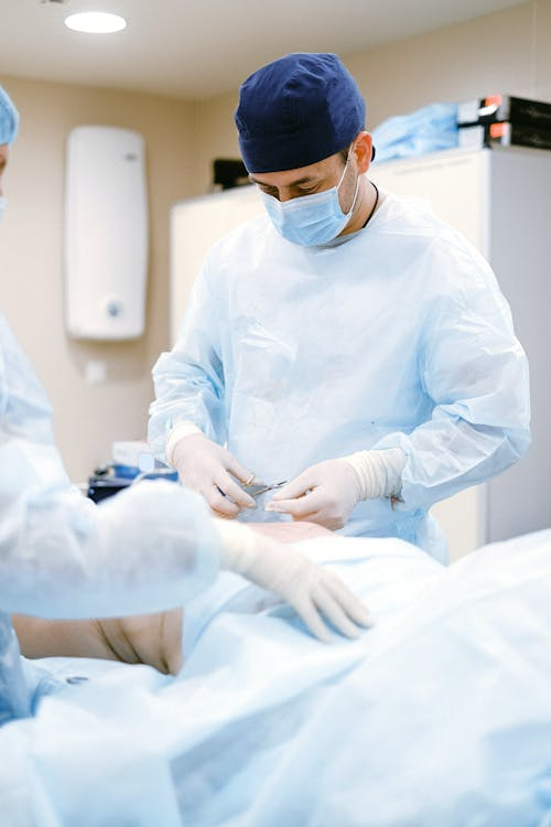 A surgeon wears a hat during a procedure.
