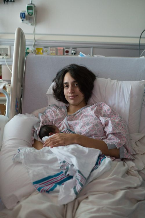 A woman resting in bed after labor.