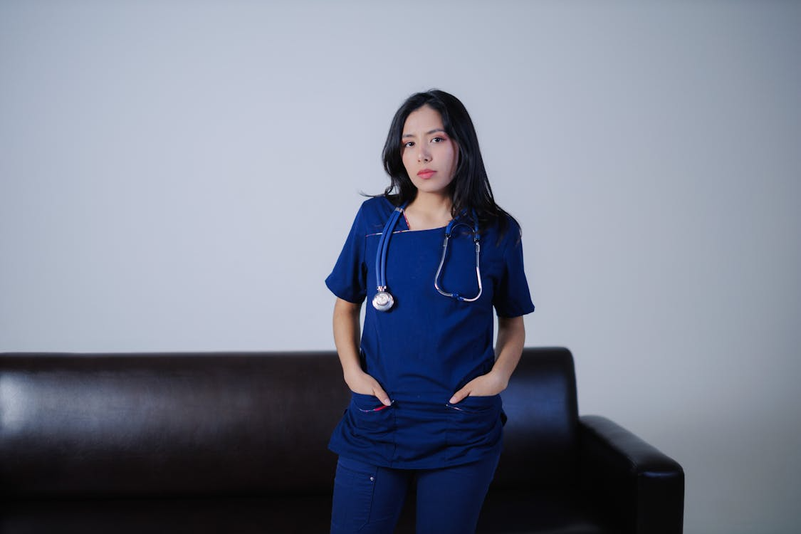A confident healthcare worker in blue scrubs.