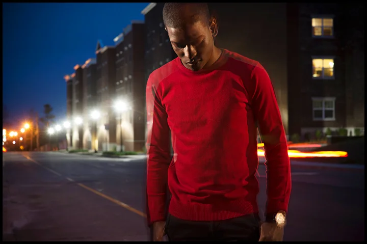 Miami senior Nick Gilyard poses for a portrait along Kentucky street where a few weeks ago he was walking up the street and a vehicle drove by, shouted a racial slur and threw a cup of ice at him. "I watch movies about racism and I've read about it," said Gilyard on Sunday, April 13, 2014. "You think you have a handle on it but it makes me feel different having something like that happen to me." Photo by Brian Powers