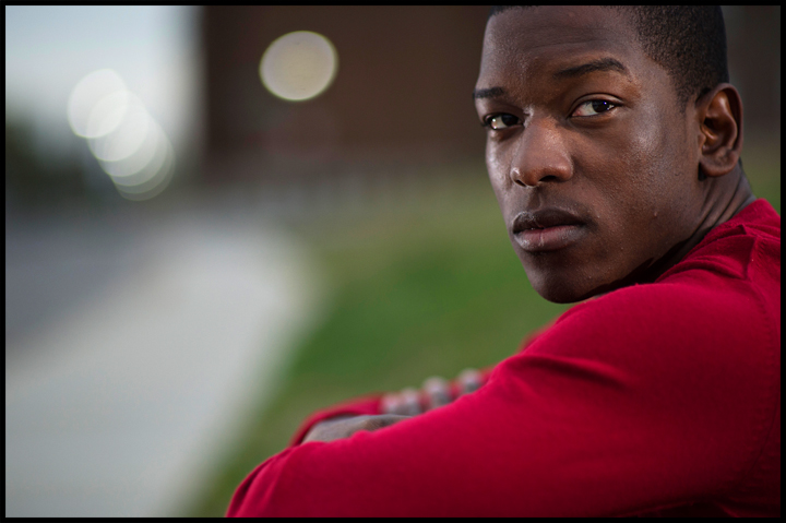 Miami senior Nick Gilyard poses for a portrait along Kentucky street where a few weeks ago he was walking up the street and a vehicle drove by, shouted a racial slur and threw a cup of ice at him. "I watch movies about racism and I've read about it," said Gilyard on Sunday, April 13, 2014. "You think you have a handle on it but it makes me feel different having something like that happen to me." Photo by Brian Powers