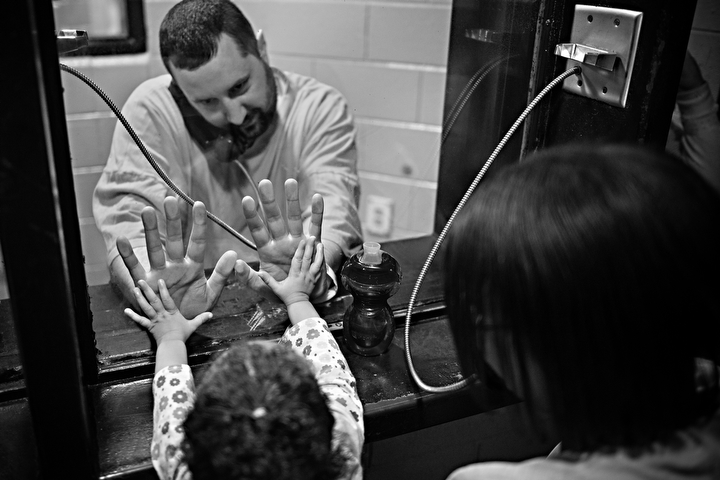 Joseph Walker and daughter Acelyhne Walker press their hands against the glass during a visit on Wednesday, Nov. 13, 2013. "I've pretty much watch my daughter grow up in here," Walker said. "It's not only like I'm in jail, it's like they are too." Photos by Brian Powers
