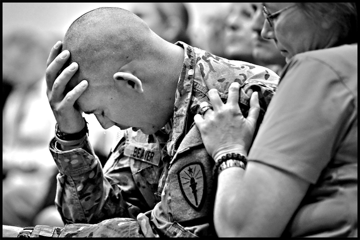 A tear is shed by Zebon Beaber from Crown Point, IN as he is comforted by Mary Patterson during a Veteran's Day Assembly at West Aurora High School on Friday, November 9, 2012. Patterson's son Chris was in Beaber's squad and was killed in action in January. TEAR