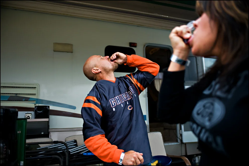 Zeke Ackert, left of Barrington, and Jennifer Craig-Biondo, right of Barrington, do a jello shot that was left over from the night before on Sunday morning at Chicagoland Speedway in Joliet, Ill on Sunday, September 18, 2011. With a scheduled 1:00 pm start officials continue to try and dry the track and stay on time. | Brian Powers~Sun-Times Media