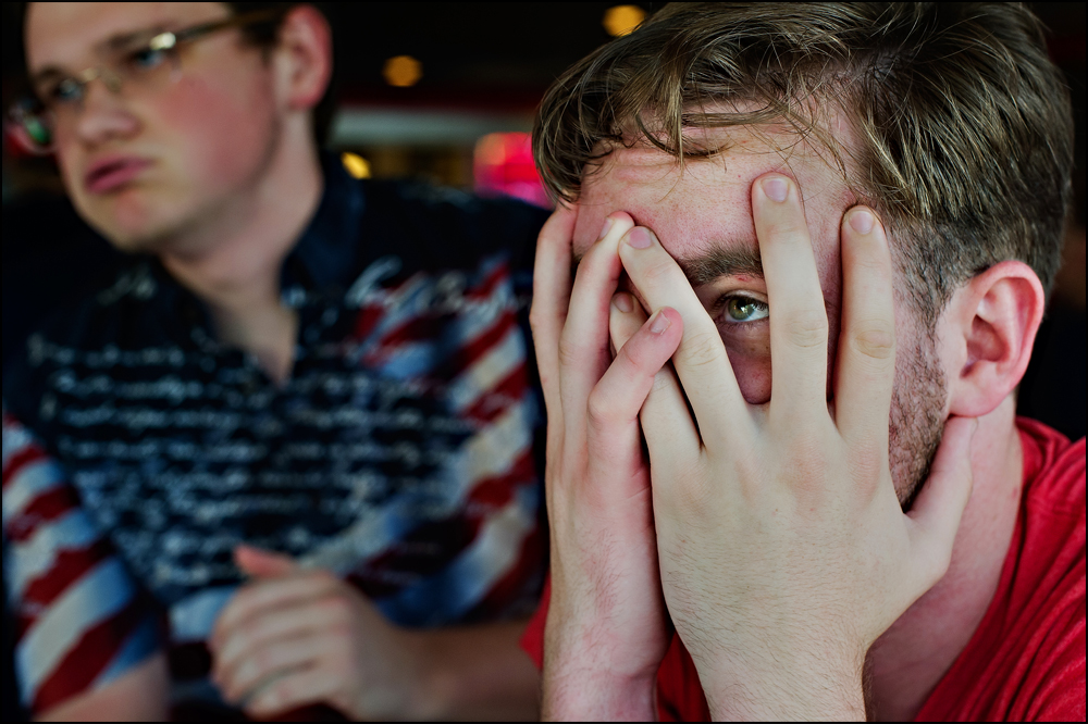  Surrounded by fans at Hilligans Sports bar in Bowling Green, Zach Younglove, 22 of McMinnville, TN, right, reacts after Team USA lost to Belgium 2-1 and was eliminated from the World Cup on Tuesday, July 1, 2014. Photos by Brian Powers 