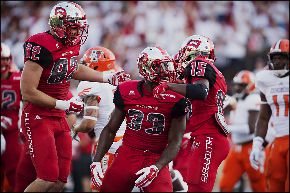  Aug 29, 2014; Bowling Green, KY, USA; Western Kentucky Hilltoppers running back Leon Allen (33) celebrates with teammates tight end Tyler Higbee (82) and wide receiver Nicholas Norris (15) after he scored the first touchdown of the game to take the 