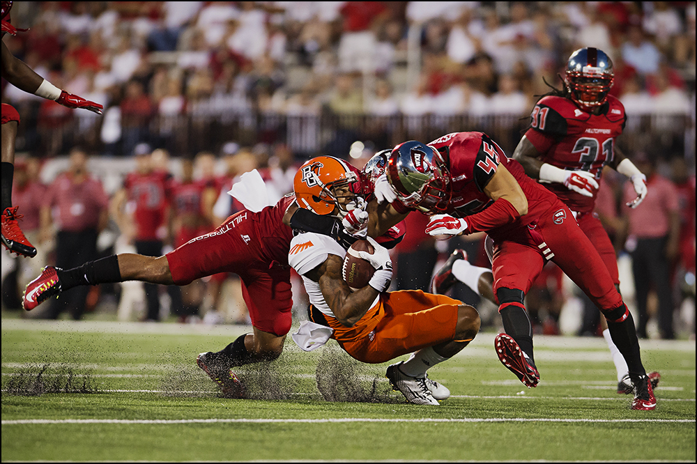  Aug 29, 2014; Bowling Green, KY, USA; Bowling Green Falcons wide receiver Roger Lewis, center, is tackled by Western Kentucky Hilltoppers defensive back Branden Leston (45) and Ricardo Singh (38) during their game  at Houchens Industries-L.T. Smith 