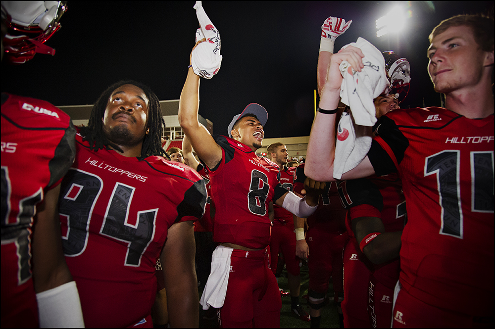  Aug 29, 2014; Bowling Green, KY, USA; Western Kentucky defensive lineman Bryan Shorter (94), defensive back Marcus Ward (8),  defensive back Juwan Gardner (14) celebrate in front of the school band after defeating the Bowling Green Falcons 59-31at H