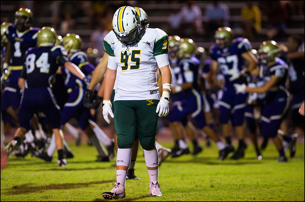  As Bowling Green celebrates behind him St. Xavier defensive end Max Willinger walks off the field after the Tigers game lost to the Purples 6-0 in overtime at Bowling Green High School on Friday, September 5, 2014. Photos by Brian Powers 