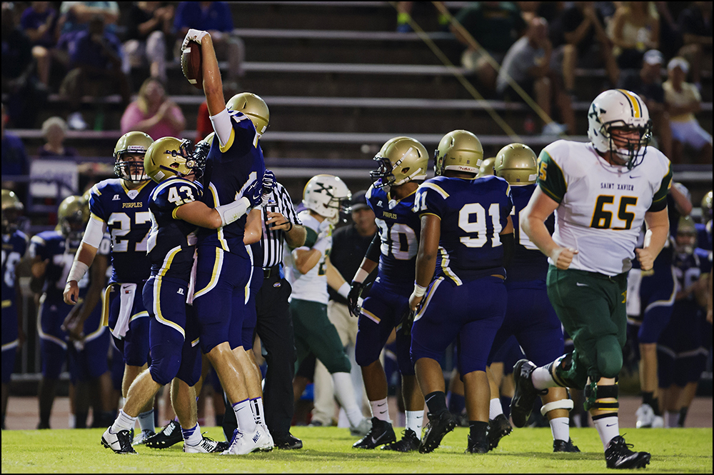  Bowling Green's Dane Drobocky (11) holds up the football after his interception of St. Xavier quarterback Noah Houk during the Tigers game against Bowling Green at Bowling Green High School on Friday, September 5, 2014. The Tigers would go on to loo