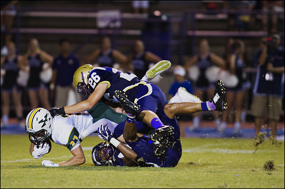  St. Xavier's Blake Roshkowski is tackled by Bowling Green's Casey Wilkins, top, and Tyrikus Boyd, bottom, during the Tigers game against Bowling Green at Bowling Green High School on Friday, September 5, 2014. The Tigers would go on to loose 6-0 in 