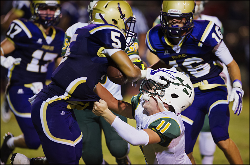  St. Xavier's Ian Kania (11) tries to tackle Bowling Green's Jacob Yates (5) during the Tigers game against Bowling Green at Bowling Green High School on Friday, September 5, 2014. The Tigers would go on to loose 6-0 in overtime. Photos by Brian Powe