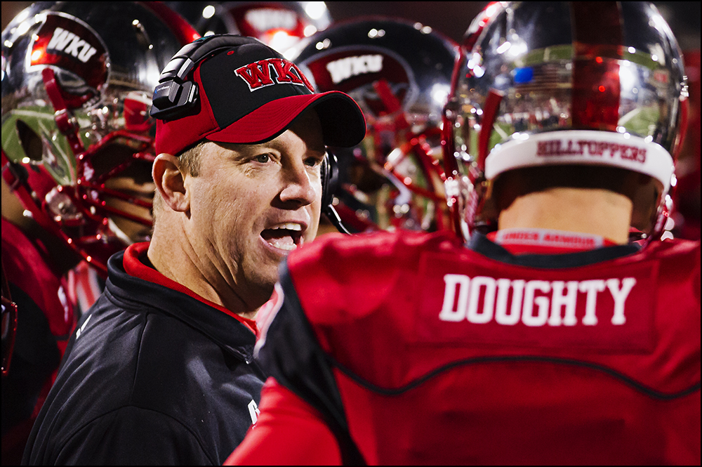  Nov 8, 2014; Bowling Green, KY, USA; Western Kentucky University head coach Jeff Brohm talks to quarterback Brandon Doughty in the fourth quarter of their game against UTEP at Houchens Industries-L.T. Smith Stadium. WKU would go on to win 35-27. Man