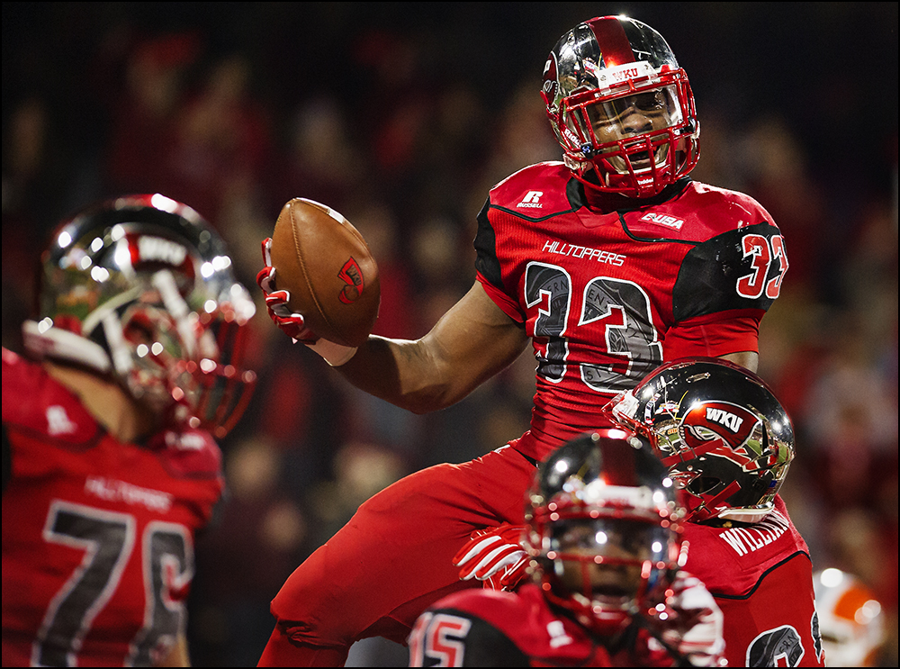  Nov 8, 2014; Bowling Green, KY, USA; Western Kentucky running back Leon Allen (33) is lifted by his teammates after scoring to make it 35-27 in the fourth quarter during the Hilltoppers game at Houchens Industries-L.T. Smith Stadium. WKU won 35-27. 