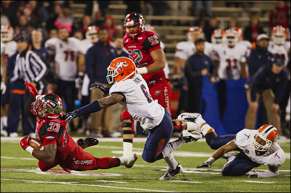  Nov 8, 2014; Bowling Green, KY, USA; Western Kentucky University running back Leon Allen (33) is tripped up by UTEP defensive back Damian Payne (6) at Houchens Industries-L.T. Smith Stadium. WKU won 35-27. Mandatory Credit: Brian Powers-USA TODAY Sp