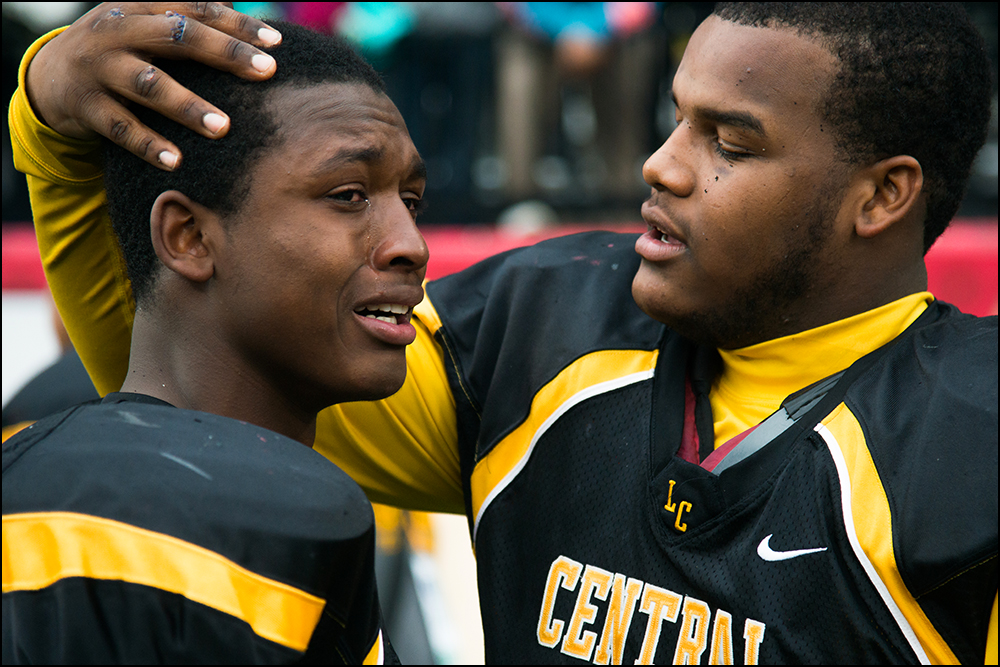  Central High School's Nate Young, left, is comforted by teammates after loosing 7-14 to Belfry at the KHSAA Commonwealth Gridiron Bowl championships at Western Kentucky University on Friday, December 5, 2014. Photo by Brian Powers 