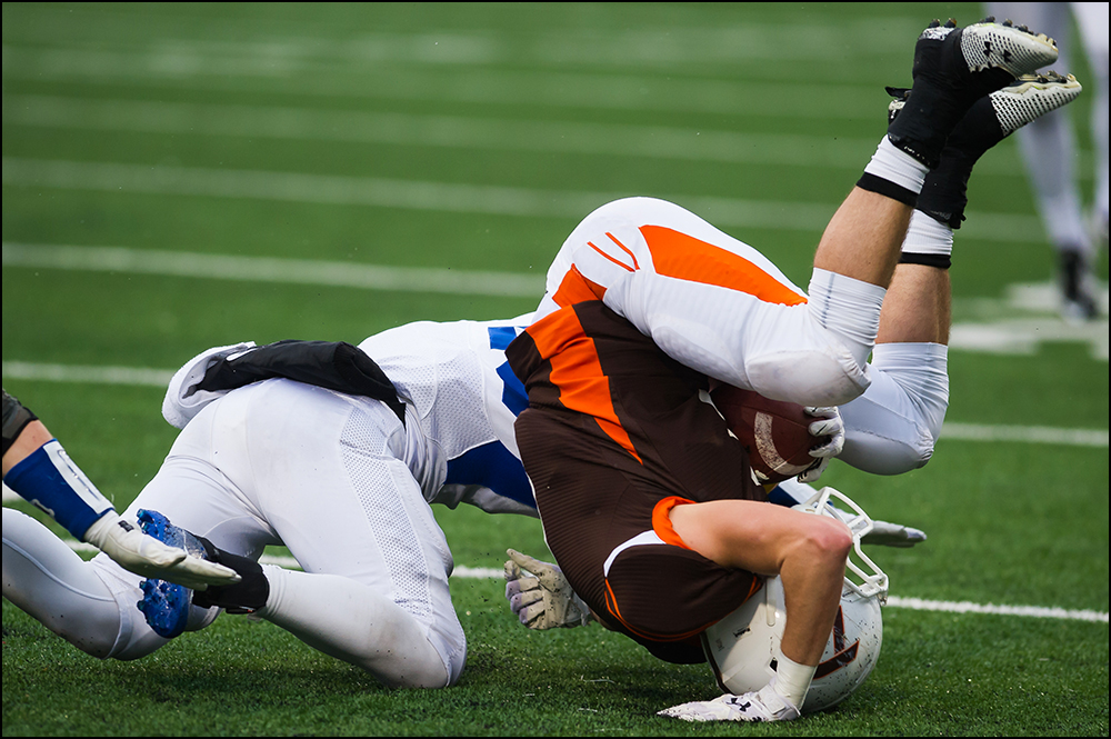  DeSales Austin Hunt us upended by Newport Central Catholic's Nathanael Enslen during their KHSAA Commonwealth Gridiron Bowl game at Western Kentucky University on Friday, December 5, 2014. DeSales would go on to win 26-0. Photo by Brian Powers 