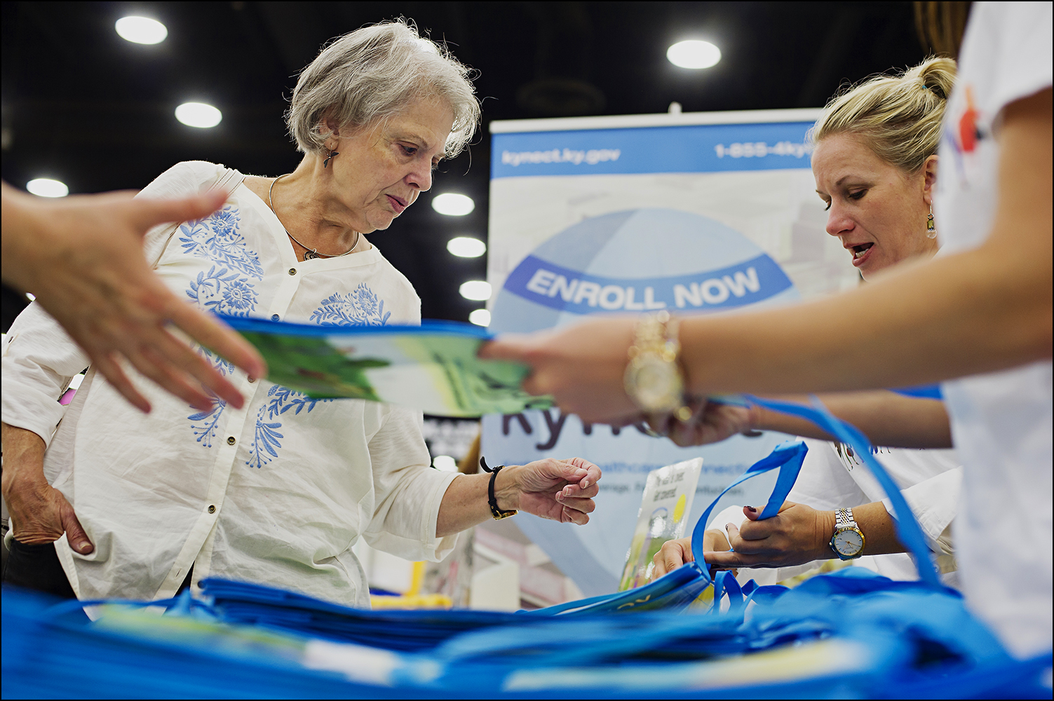  Jean Varble, 65, from Louisville, left, picks up information on the Affordable Health Care Act from the Kynect booth at the Kentucky State Fair in Louisville, KY on Thursday, August 21, 2014. Varble said that while she and her husband have a pension