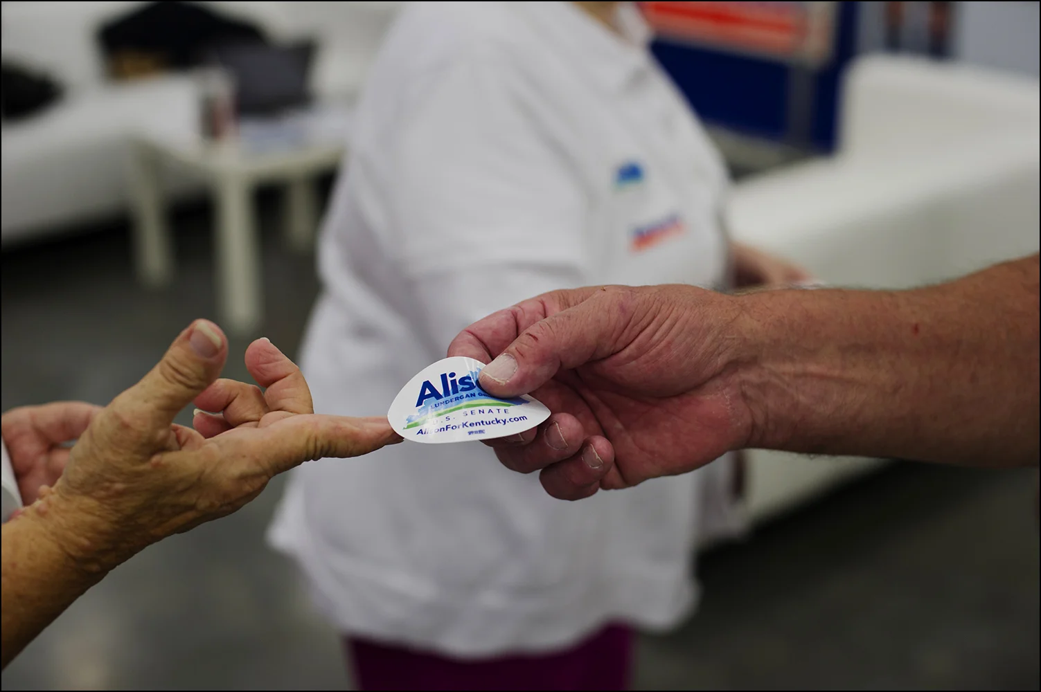 Supporters of U.S. Senate candidate Alison Lundergan Grimes pick up stickers at the Democrats booth inside the the Kentucky State Fair in Louisville, KY on Thursday, August 21, 2014. Photos by Brian Powers