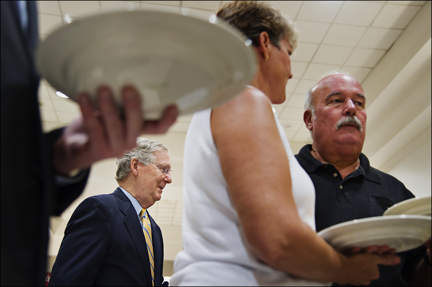  U.S. Senate Minority Leader Mitch McConnell talks with attendees before the 51st annual Kentucky Country Ham Breakfast at the state fair in Louisville, KY on Thursday, August 21, 2014. Photos by Brian Powers 