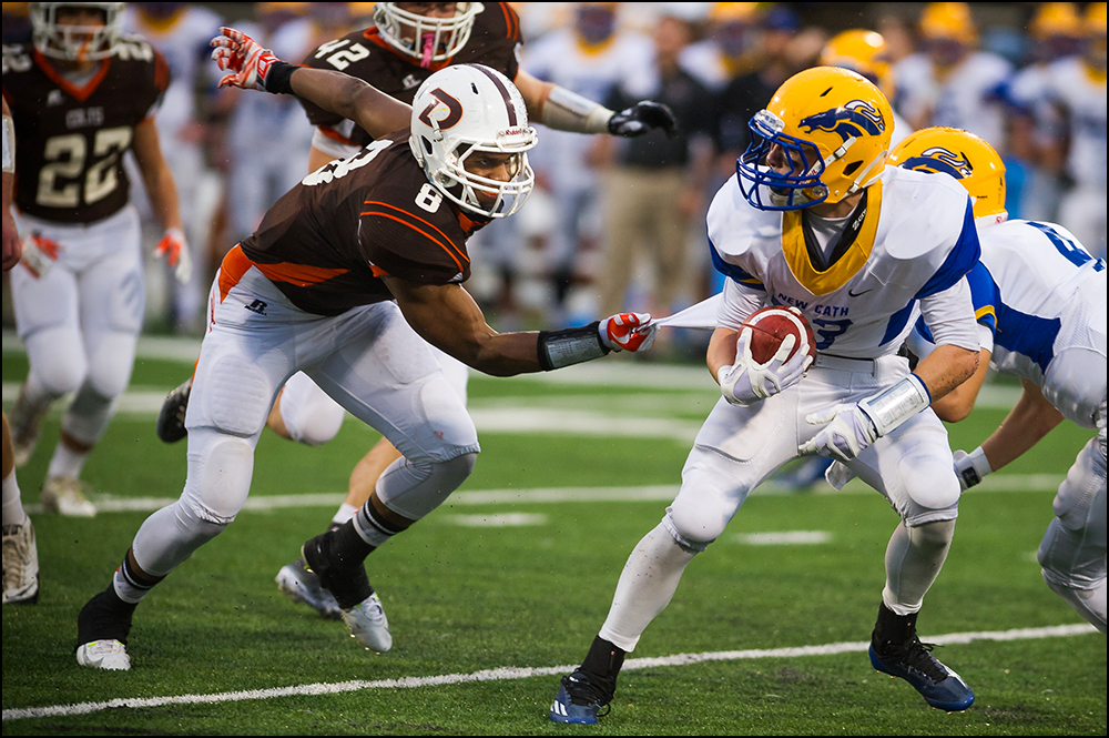  Desales Bryant Pirtle, jr. olds onto Newport Central Catholic's Nathanael Enslen during the first half of their 2A championship game at the KHSAA Commonwealth Gridiron Bowl at Western Kentucky University on Friday, December 5, 2014. Photo by Brian P