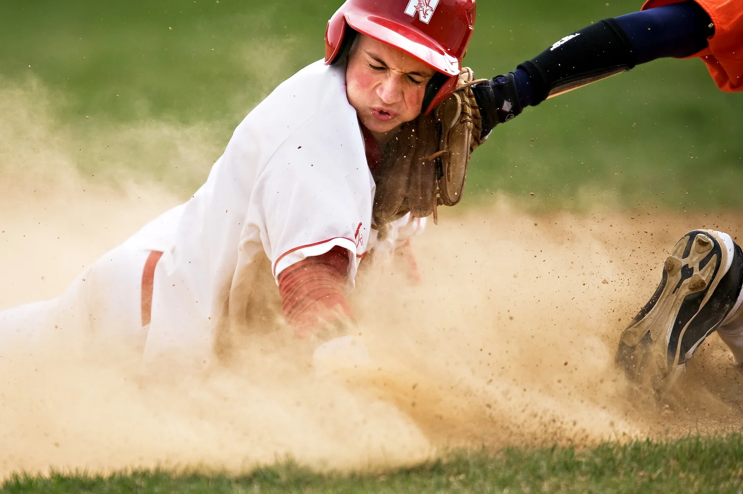  With the ball lost in the dust, Naperville Central's Nick Ryan slides in safely to third base during their game against Oswego at Naperville Central on Tuesday, March 27, 2012. | Brian Powers~Sun-Times Media 