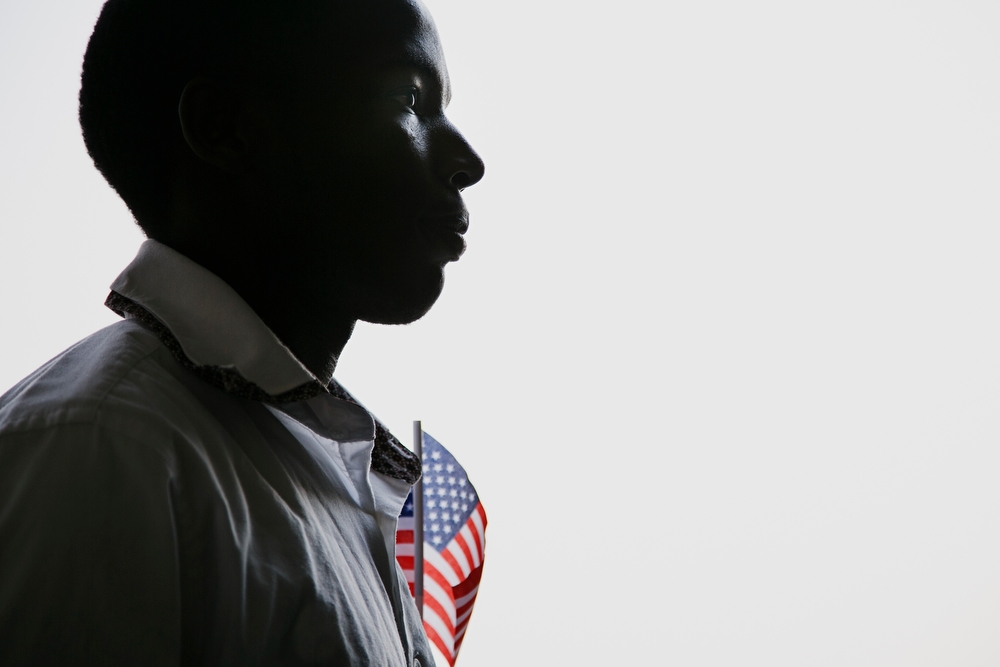  Alex Degoce Niyonyinshu, 23 from Burundi, waits in line before walking out onto the field at Principal Park for a naturalization ceremony to 30 new United States citizens from 14 different countries in Des Moines on Friday, July 3, 2015. Niyonyinshu