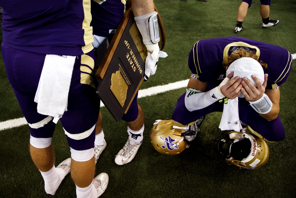  Norwalk's Devin Pickle, right, holds his head after loosing to Pella, 17-31 in the class 3A state championship game at the UNI-Dome in Cedar Falls on Thursday, November 19, 2015.
 