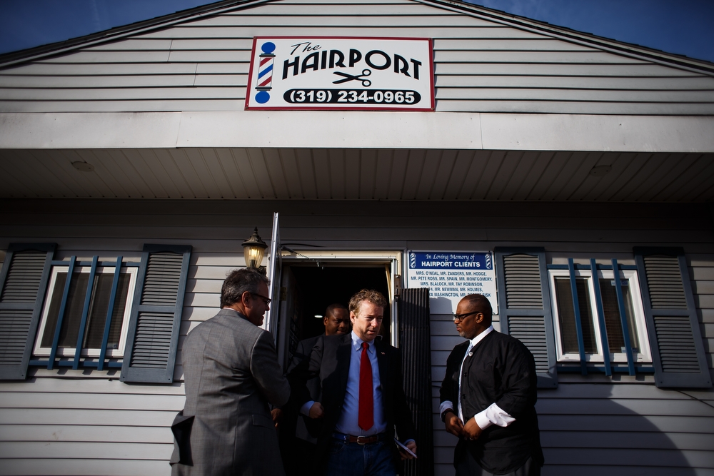  Republican presidential candidate Rand Paul walks outside after talking to residents during a campaign stop at the Hairport Barber shop on Saturday, December 05, 2015 in Waterloo. 