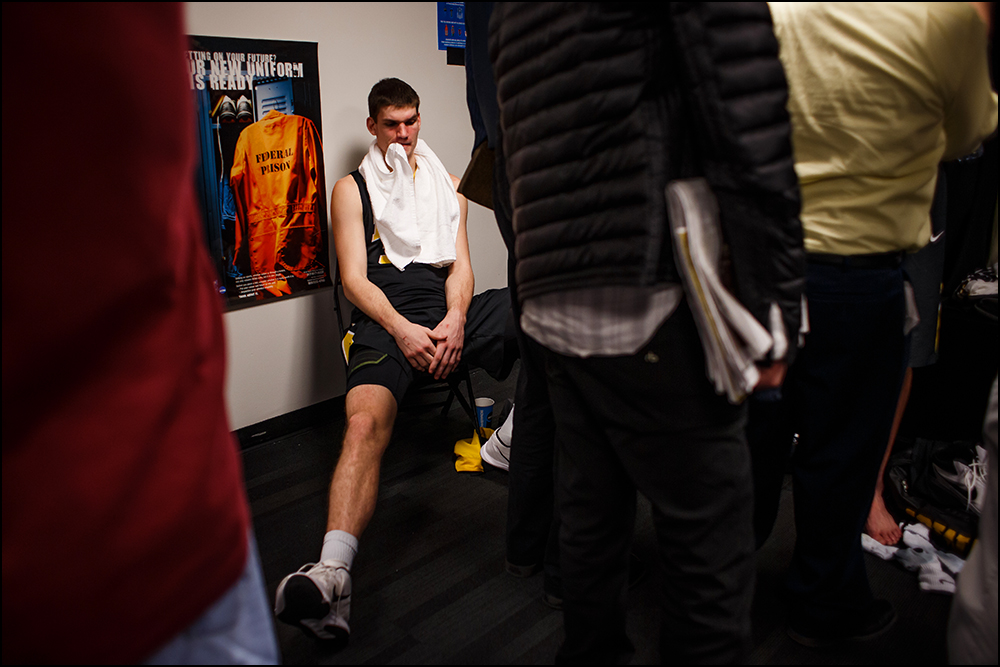  Iowa’s Adam Woodbury (34) sits in the locker room as media members ask his teammates questions after their 87-68 loss to Villanova at their second round NCAA Basketball Championship game on Sunday, March 20, 2016 in New York City, New York. 