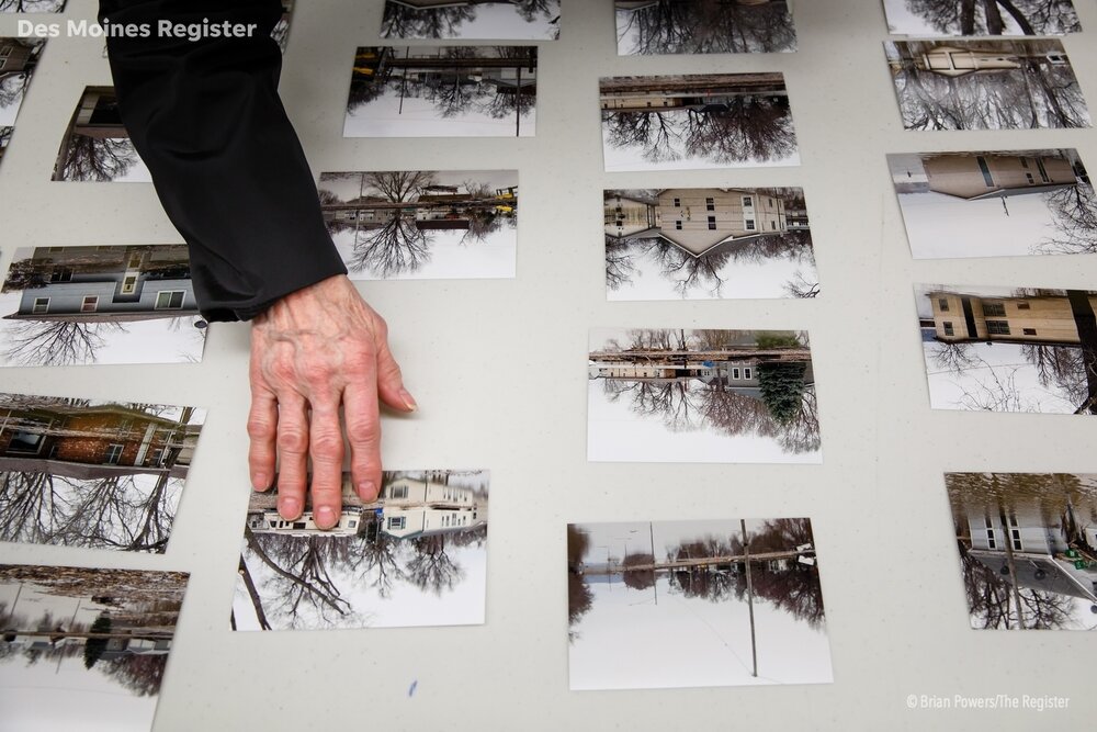  Pacific Junction residents look through photos spread on tables of all the homes in town on Wednesday, April 3, 2019, in Glenwood. For many, this was the first time they had seen their since being evacuated a week earlier before the flooding came. 