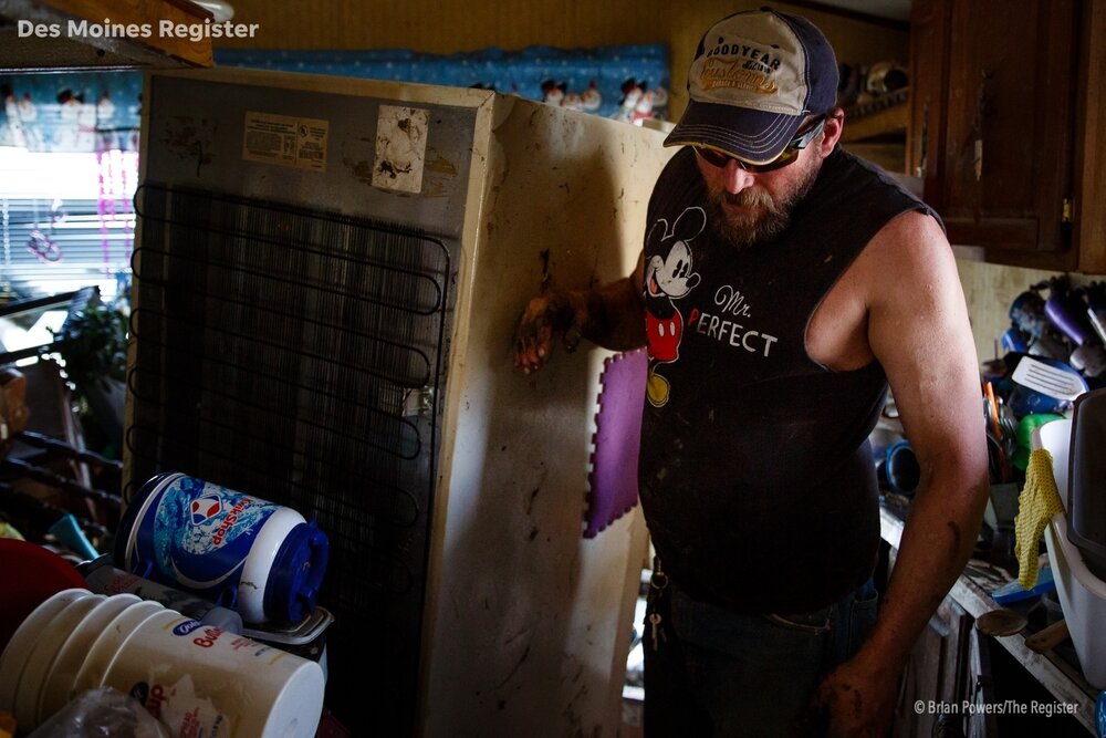   Chris Elben of Osceola helps clean out the flood damaged home of his friends Mary and Danny Manchester on Tuesday, April 16, 2019, in Pacific Junction.  